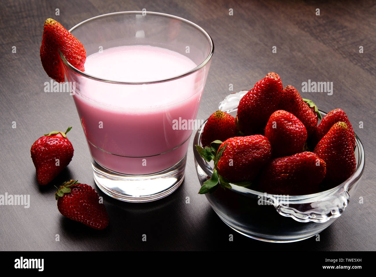 Fresh, ripe and juicy strawberry fruits in a bowl with a glass of ...