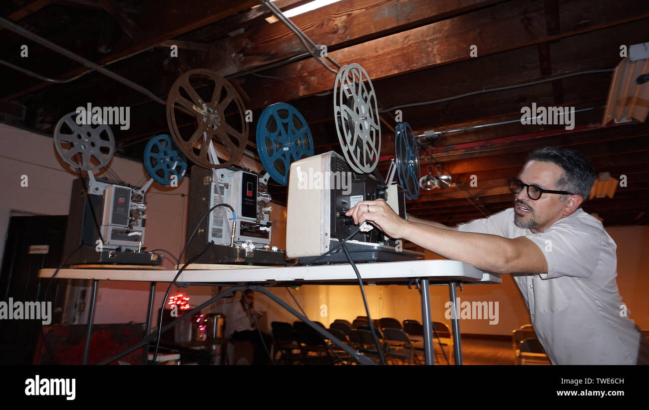 Man preparing 16mm projector for art film performance, Temescal Center for the Arts, Oakland, California Stock Photo