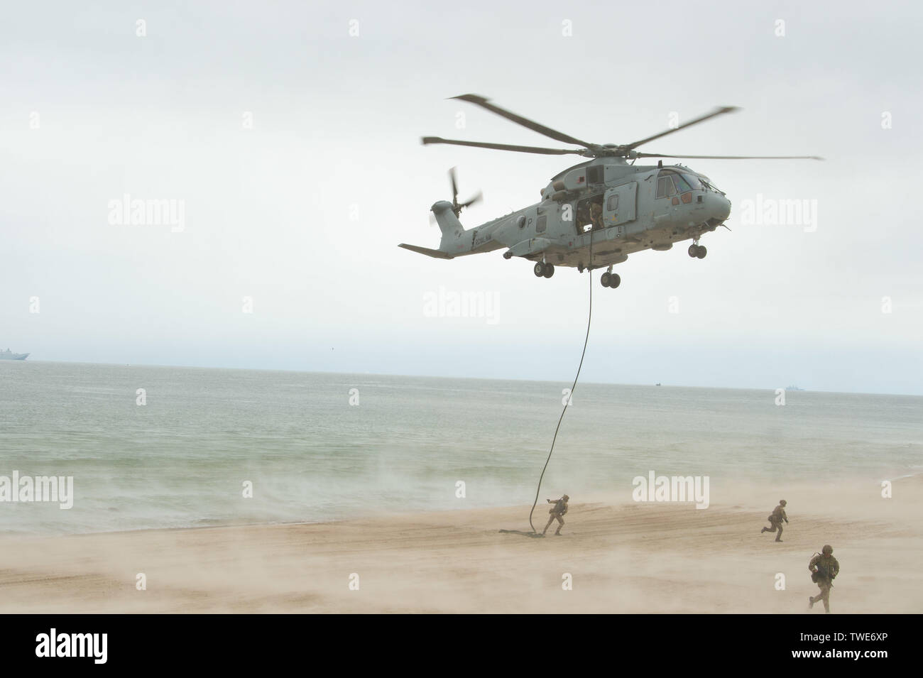 190616-N-MD802-1303 KLAIPEDA, Lithuania (June 16, 2019) Merlin MK 4 helicopters from Royal Navy Commando Helicopter Force disembark Royal Marines of 45 Commando via fast rope as part of an amphibious assault for exercise Baltic Operations (BALTOPS) 2019. BALTOPS is the premier annual maritime-focused exercise in the Baltic Region, marking the 47th year of one of the largest exercises in Northern Europe enhancing flexibility and interoperability among allied and partner nations. (U.S. Navy photo by Mass Communication Specialist 3rd Class Jack D. Aistrup/Released) Stock Photo