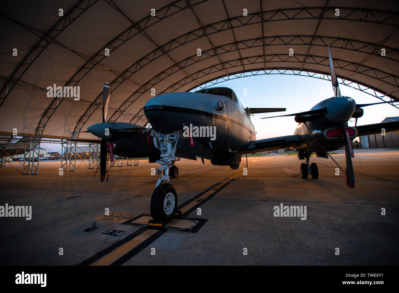 A 137th Special Operations Wing MC-12W awaits an early morning preflight inspection at Will Rogers Air National Guard Base in Oklahoma City, May 22, 2018. The MC-12 is a twin-engine turbo prop aircraft used to gather intelligence, surveillance and reconnaissance to support ground forces around the world. (U.S. Air National Guard photo by Senior Airman Jordan Martin) Stock Photo