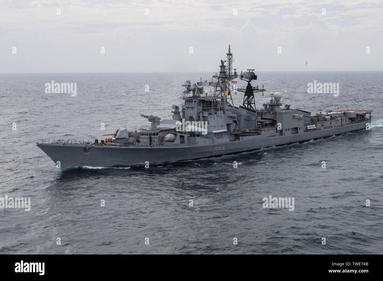190614-N-NB544-1684 INDIAN OCEAN (June 14, 2019) The Indian navy Rajput-class destroyer INS Ranvijay (D55) steams behind the the San Antonio-class amphibious transport dock ship USS John P. Murtha (LPD 26) during a photographic exercise. John P. Murtha is currently on its first deployment and part of the Boxer Amphibious Ready Group (ARG) and the 11th Marine Expeditionary Unit (MEU) team and is deployed to the 7th Fleet area of operation to support regional stability, reassure partners and allies, and maintain a presence postured to respond to any crisis ranging from humanitarian assistance to Stock Photo