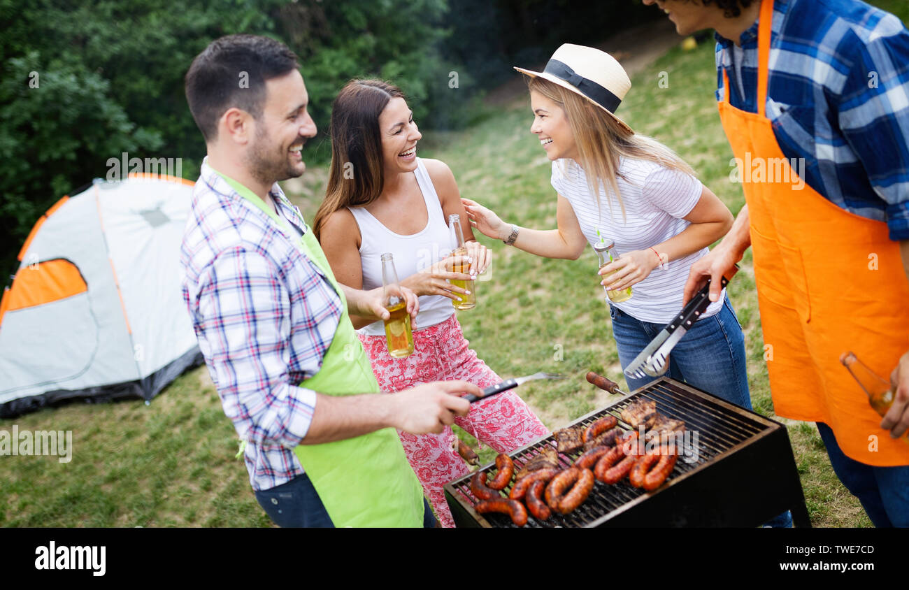 Group of happy friends having a barbecue party in nature Stock Photo ...