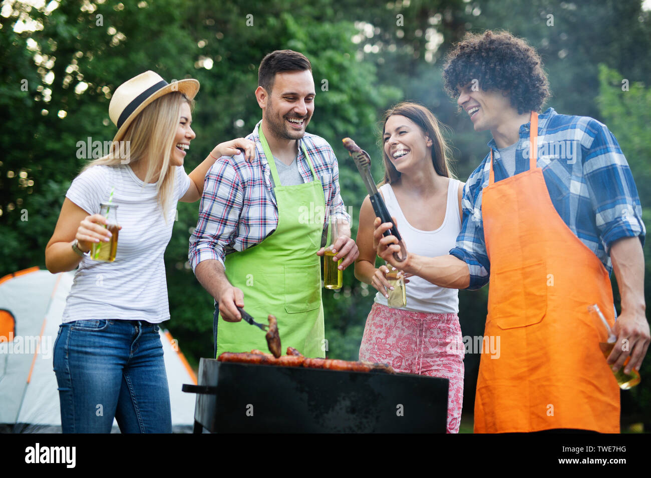 Group of happy friends having a barbecue party in nature Stock Photo ...
