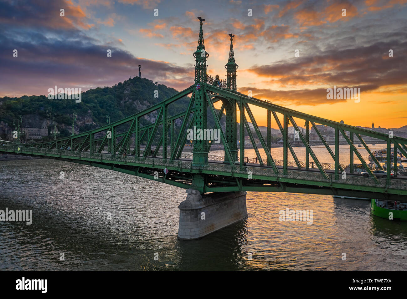 Budapest, Hungary - Beautiful sunset over River Danube with Liberty Bridge, Gellert Hill and Statue of Liberty at background Stock Photo