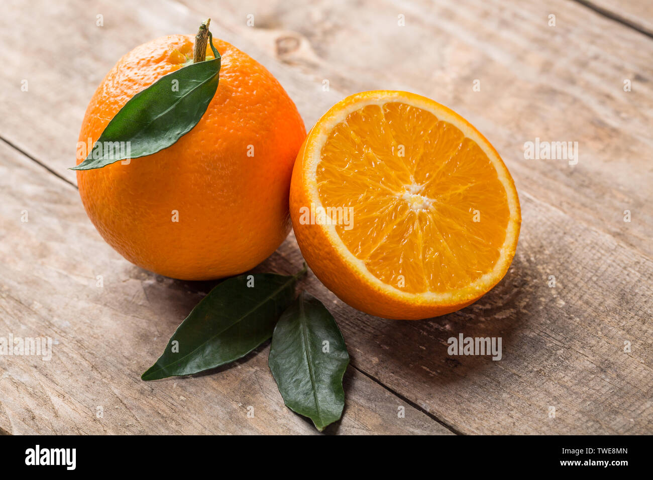 Fresh oranges on the table, one and half oranges on the table Stock Photo