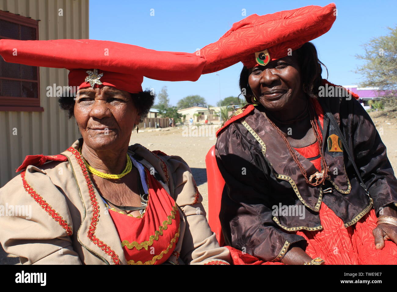 Okahandja, Namibia. 04th June, 2019. Women of the Namibian Herero tribe in their traditional Victorian costume in the city of Okahandja. The left sitting Veronika Uazapi Kandambo (75, left) is a little more light-skinned than usual in Namibia, because her grandmother was pregnant by a German farmer during the German colonial period. Credit: Jürgen Bätz/dpa/Alamy Live News Stock Photo