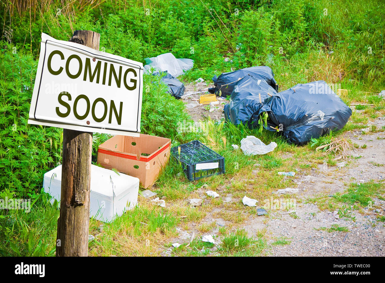 Illegal dumping abandoned in nature whit coming soon sign concept