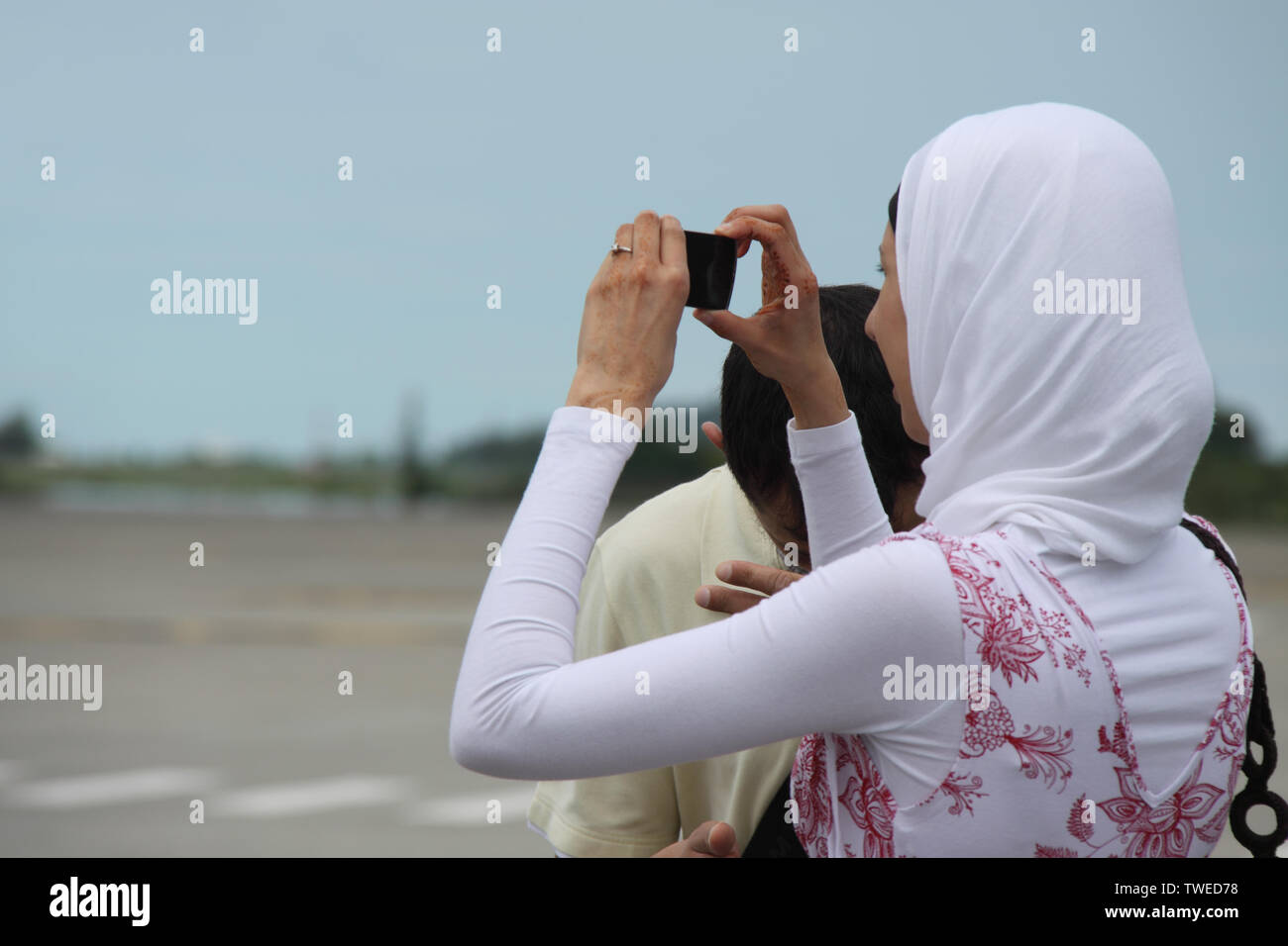 Woman taking picture with a digital camera, Malaysia Stock Photo