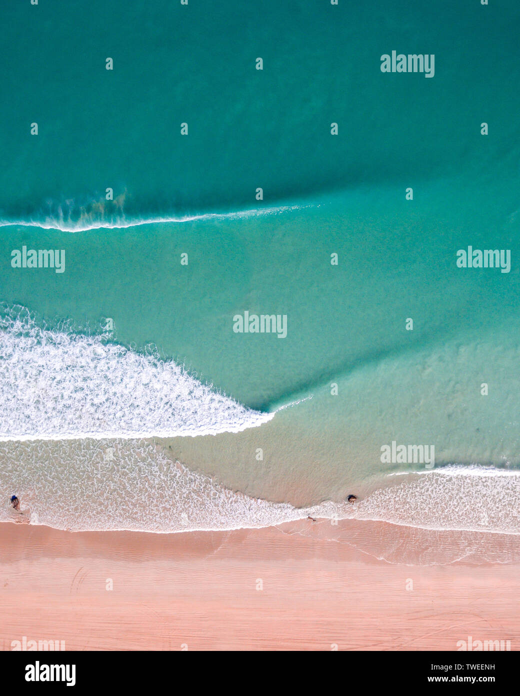 An aerial drone photograph of the beautiful turquoise water of the Indian Ocean and waves breaking on cable beach in Broome, Western Australia. Stock Photo