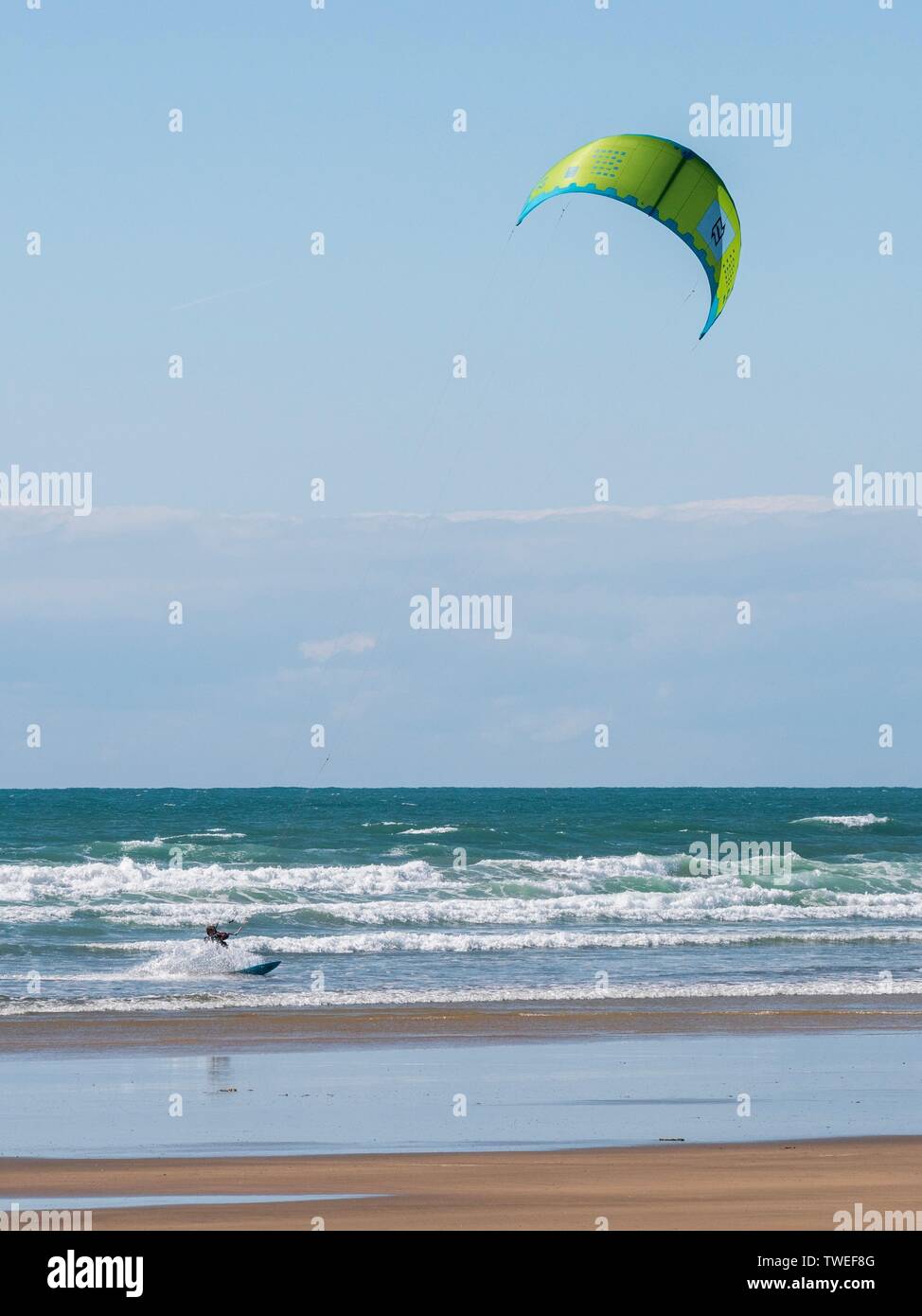A kiteboarder on the sea at a shallow beach in Devon, UK Stock Photo