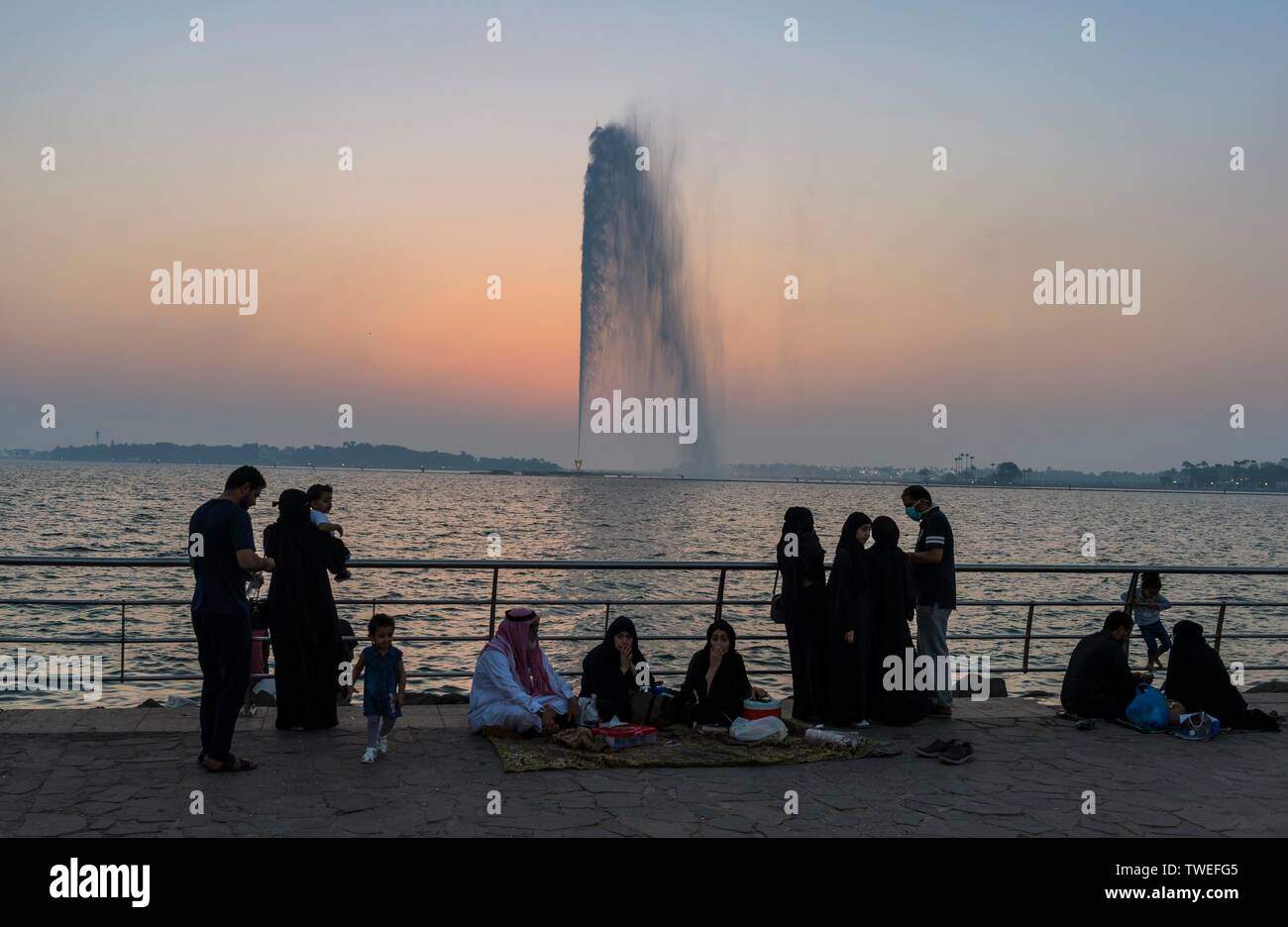 Arabian people sitting at water, King Fahd's Fountain, largest fountain in the world, Corniche Jeddah, Saudi Arabia Stock Photo
