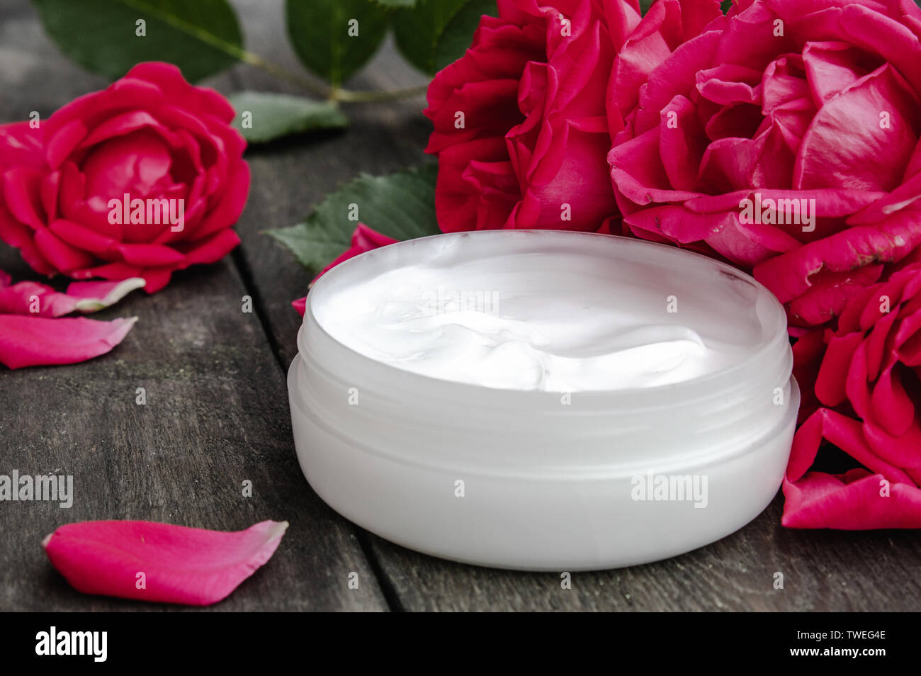 Natural flower cosmetics with red pink flowers for face and body care