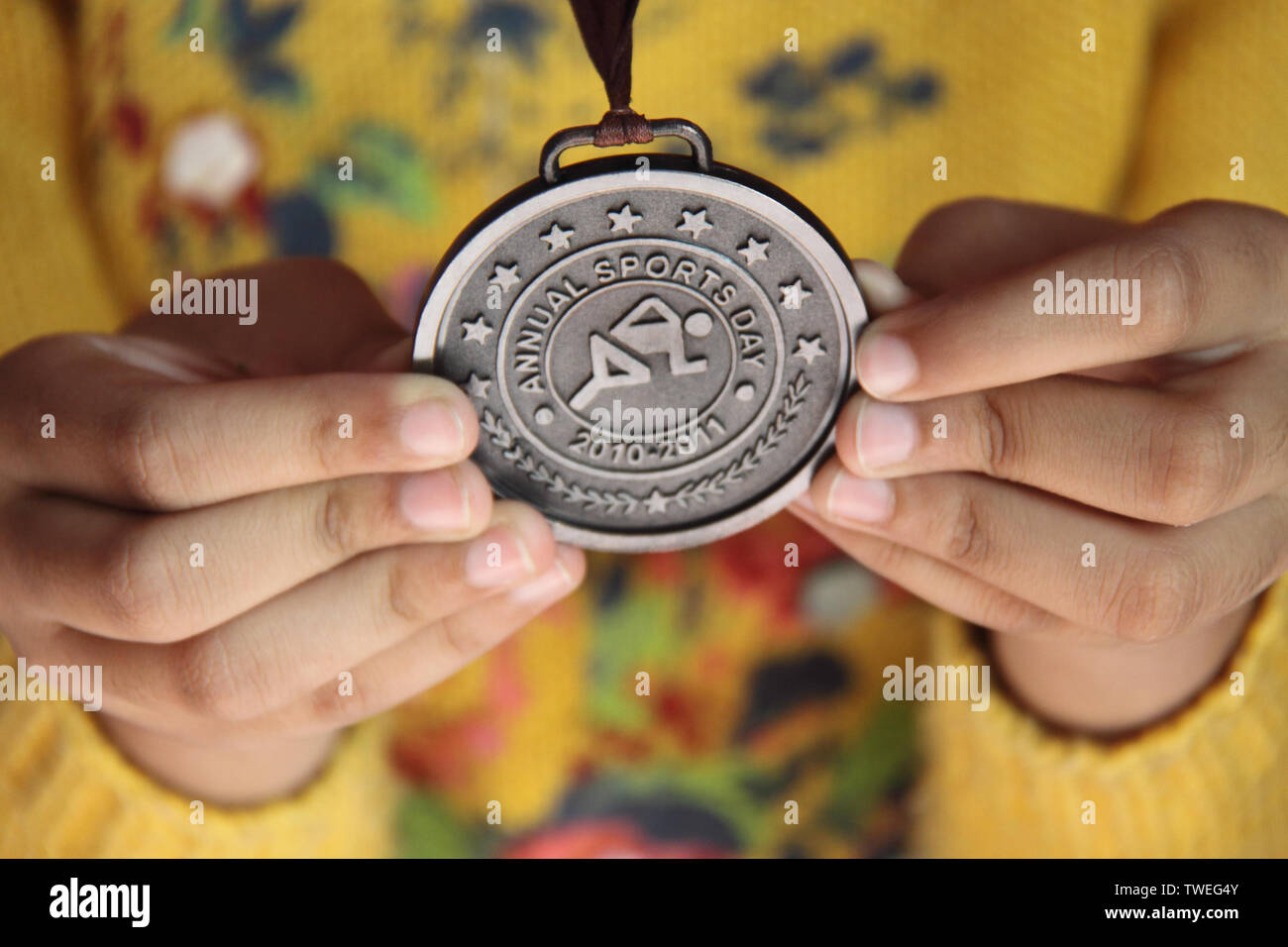 Close up of a student showing a bronze medal Stock Photo