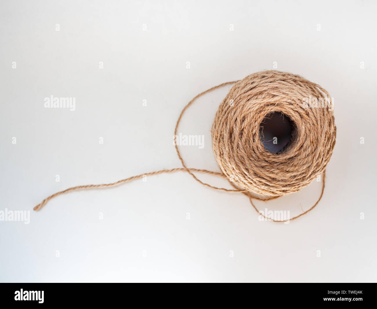 https://c8.alamy.com/comp/TWEJ4K/skein-of-jute-twine-isolated-on-white-background-with-copy-space-roll-of-natural-jute-rope-top-view-TWEJ4K.jpg