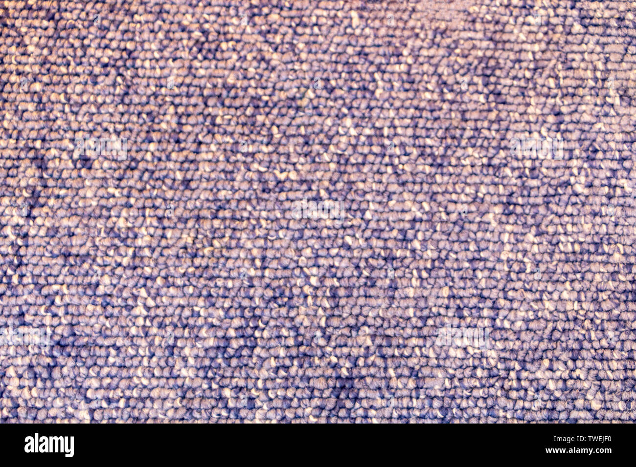 Closeup of a blue and white speckled floor carpet with loops Stock
