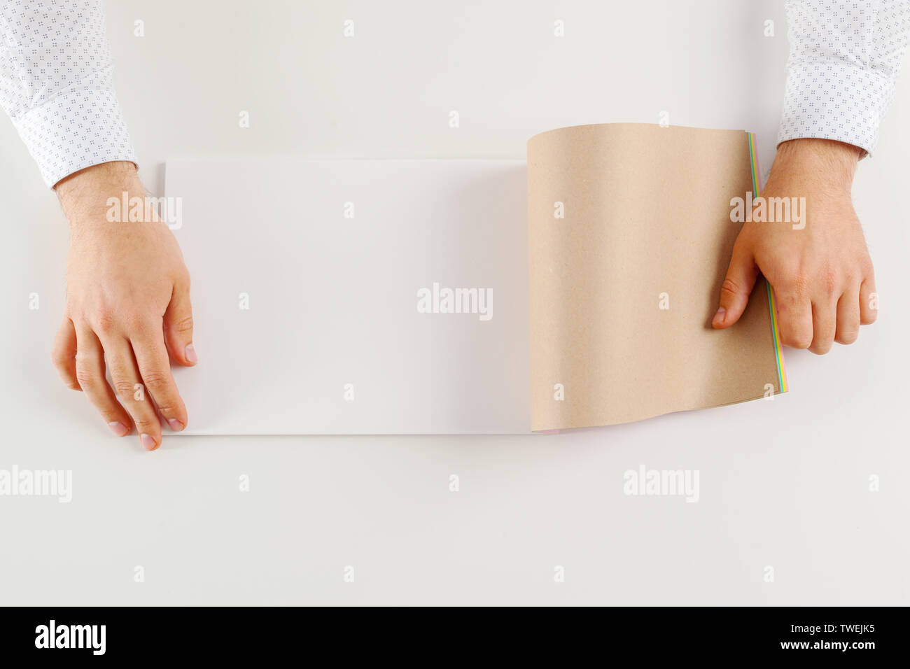 Hand holding blank opened book mock up Stock Photo