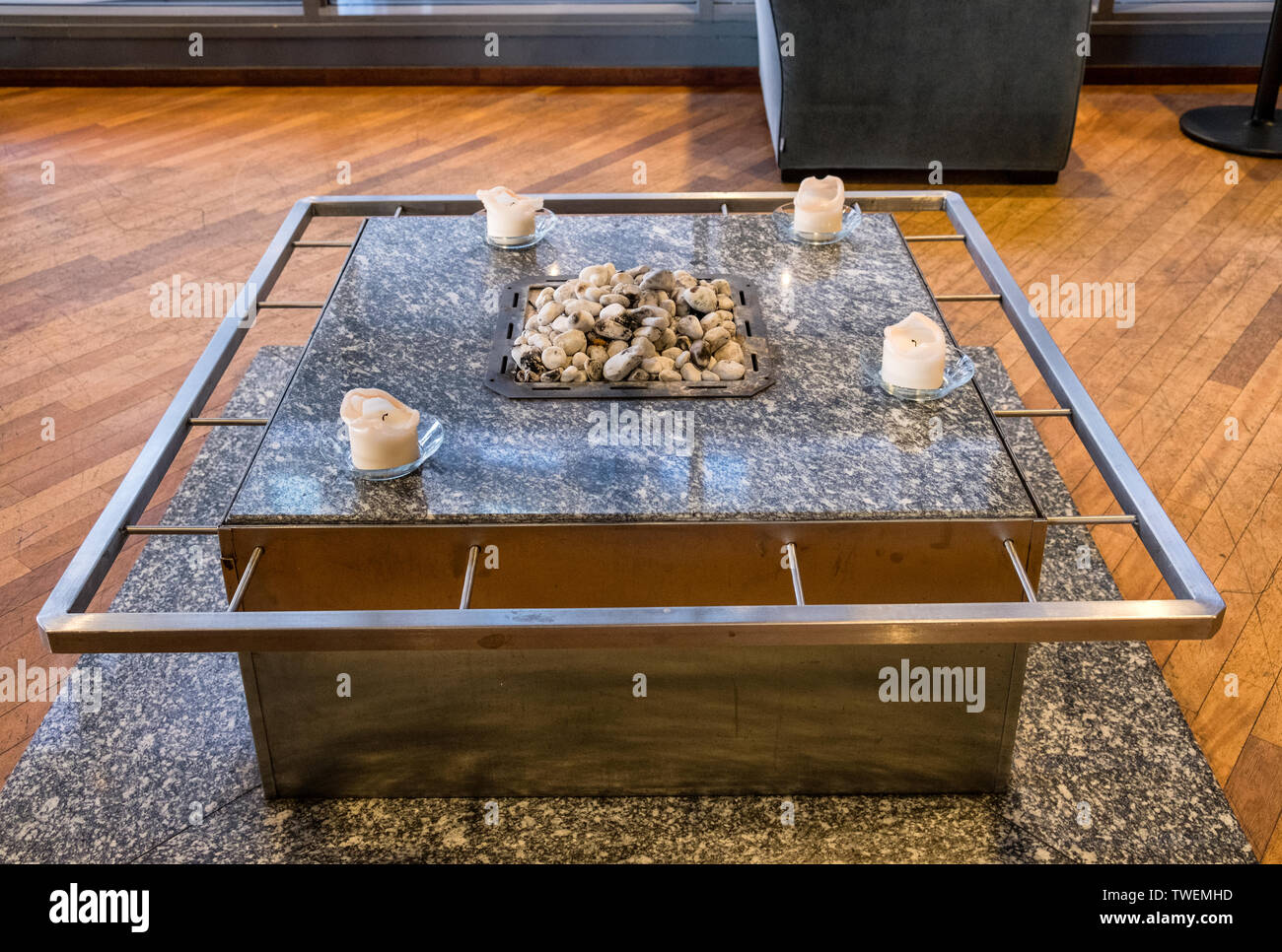Marble table with rock on fireplace and candle in living room Stock Photo