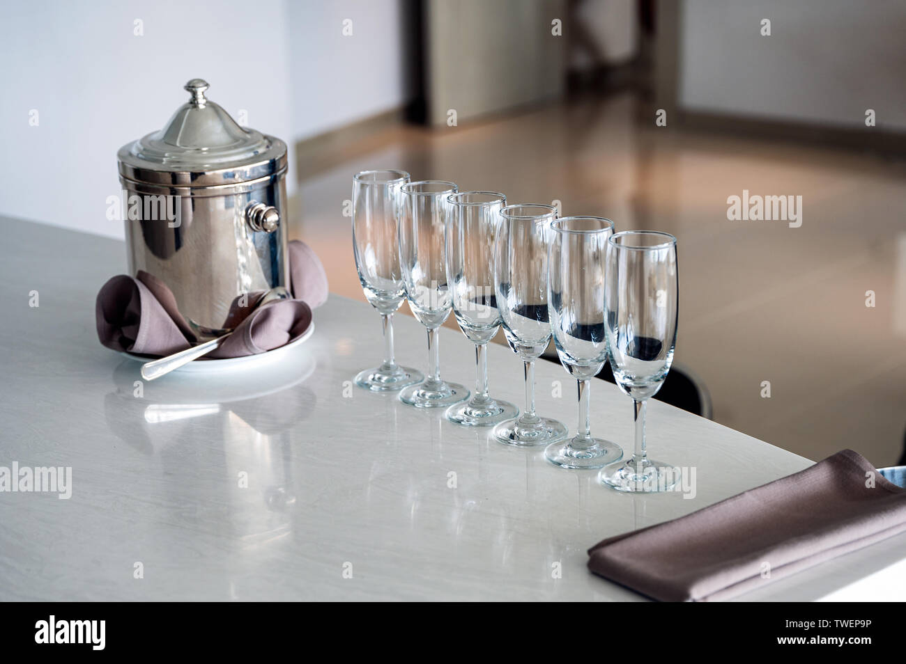 Arrangement of wine glass with stainless bucket on marble bar Stock Photo