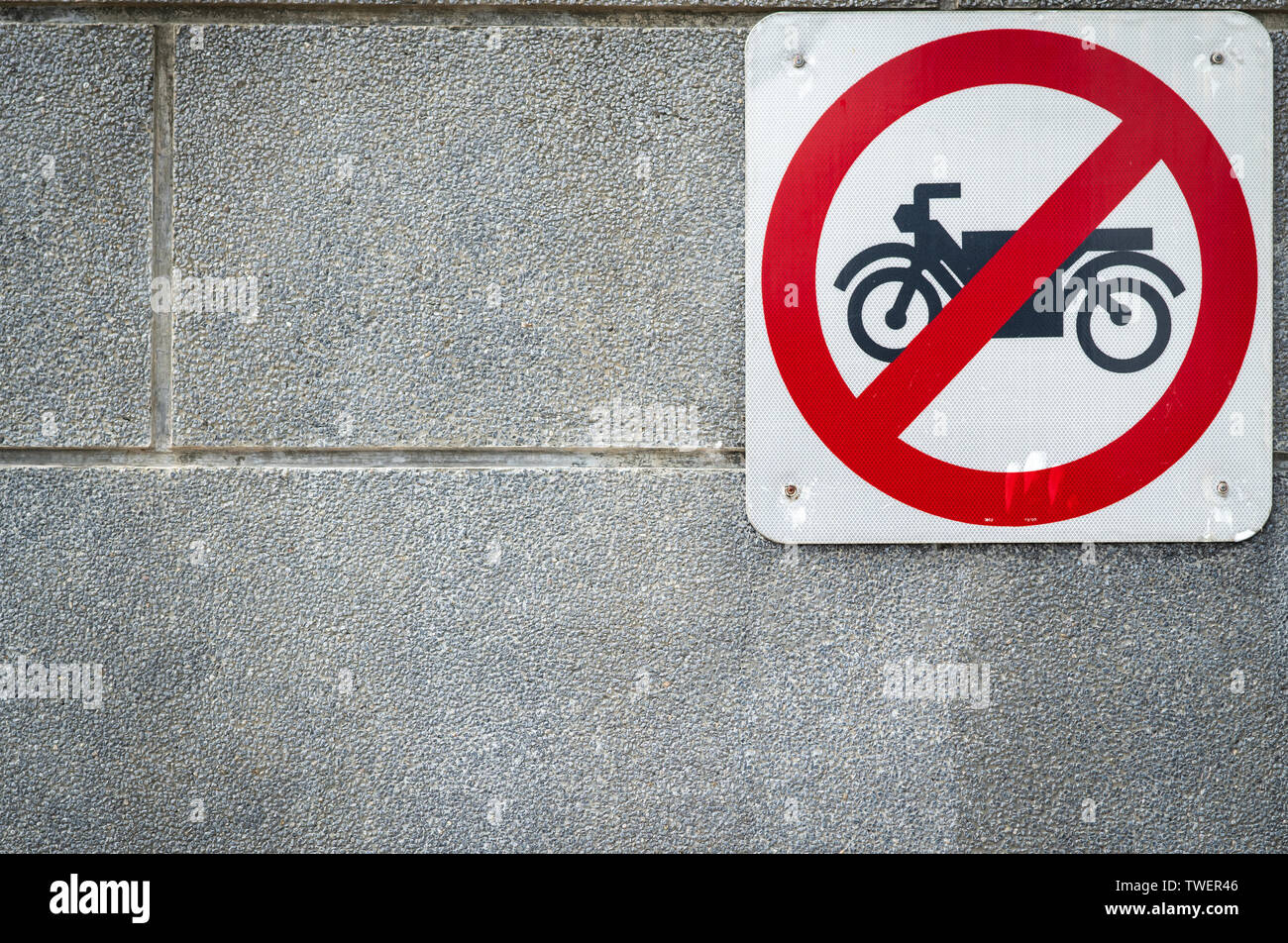 Motorcycle no entry sign install on concrete wall in front of tunnel