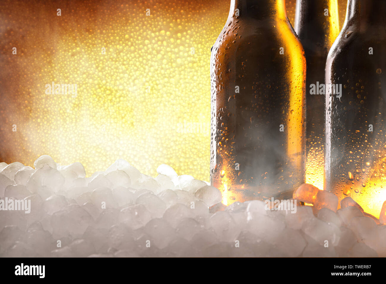 https://c8.alamy.com/comp/TWERB7/three-full-beer-bottles-on-crushed-ice-and-golden-background-close-up-horizontal-composition-front-view-TWERB7.jpg