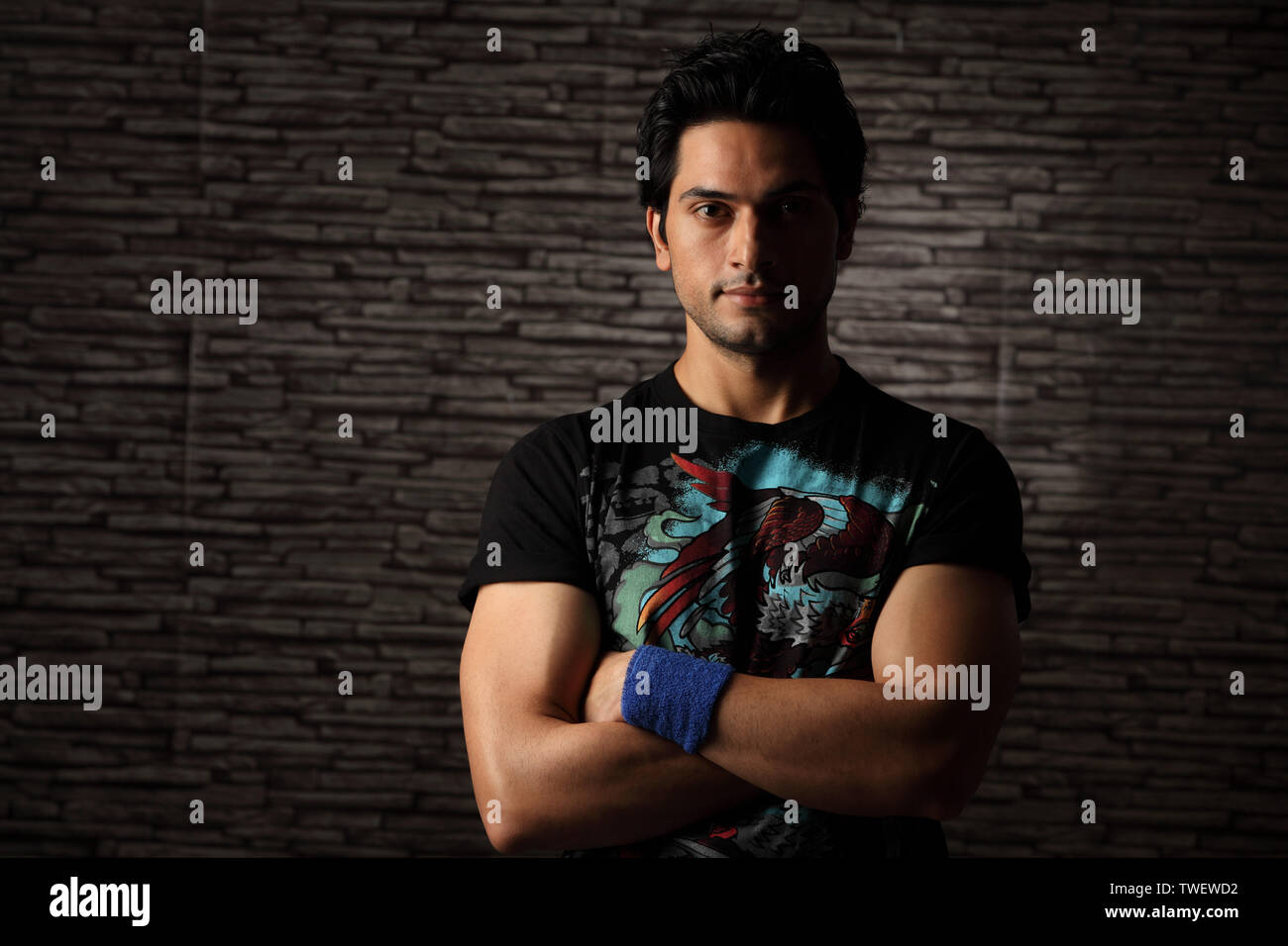 Portrait of an Indian young man with his arms crossed Stock Photo - Alamy