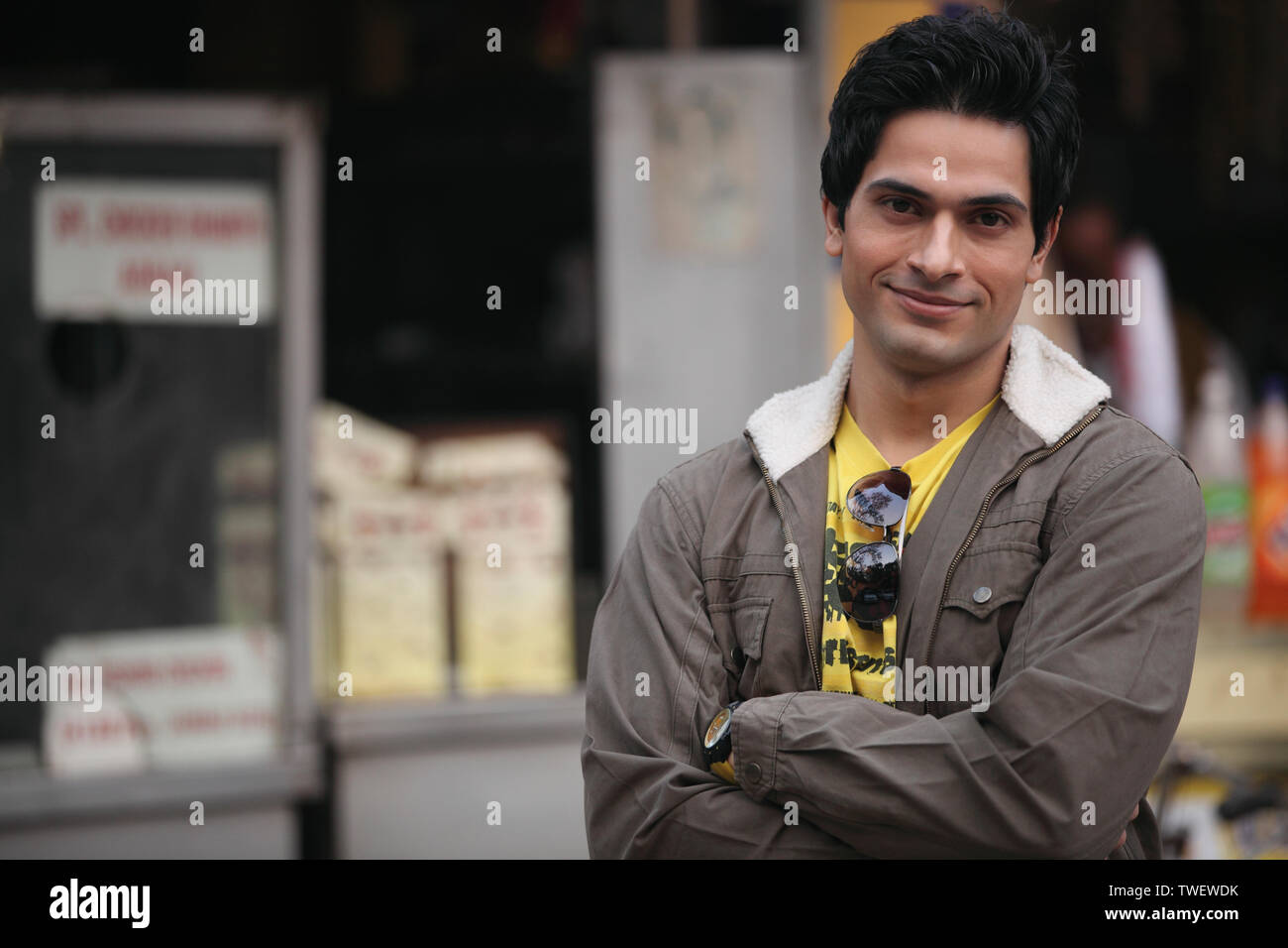 Portrait of an Indian young man with arms crossed Stock Photo - Alamy