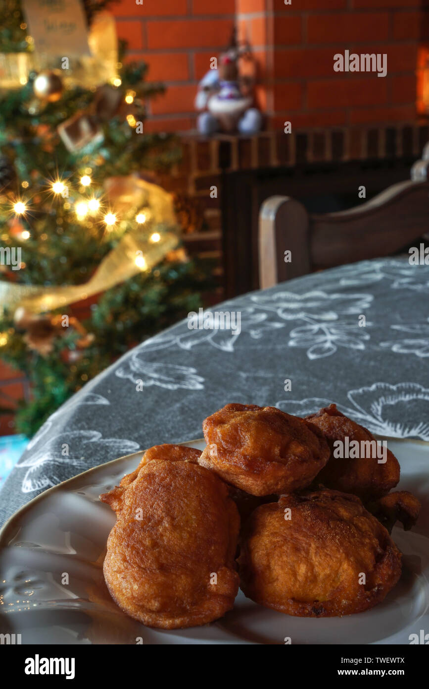 Plate with bilharaco, a traditional Portuguese pastry and sweet. Blurry background with Christmas lights and decorations Stock Photo