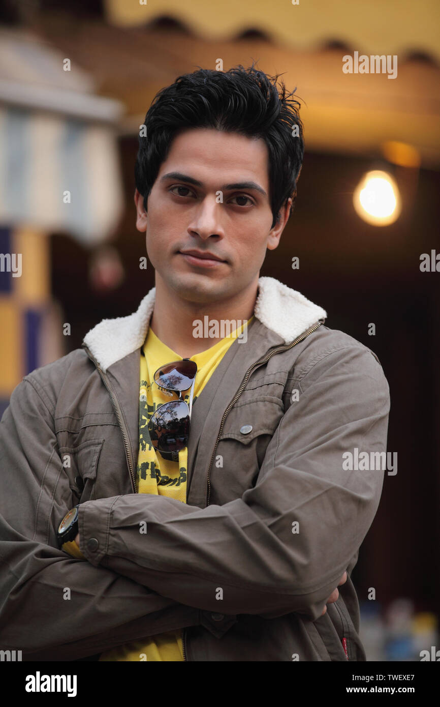 Portrait of an Indian young man with his arms crossed Stock Photo - Alamy