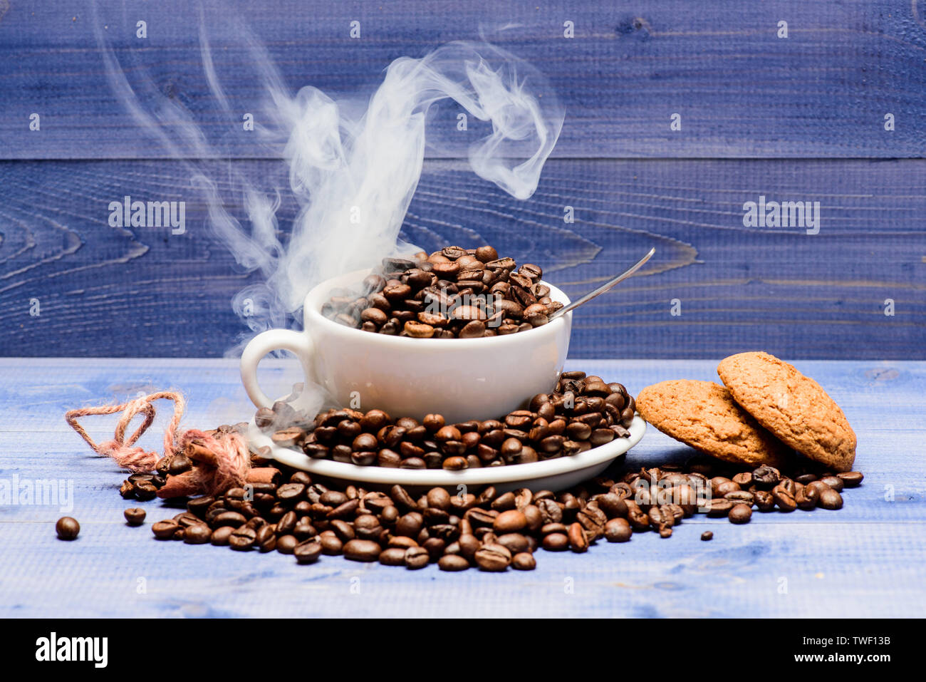 Degree Of Roasting Grain Cafe Drinks Menu Fresh Roasted Coffee Beans Coffee For Inspiration And Energy Charge Cup Full Coffee Brown Roasted Beans White Clouds Of Smoke Blue Wooden Background Stock Photo