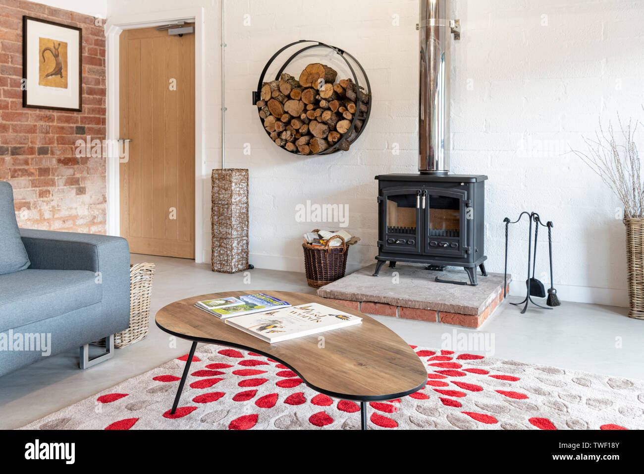 A wood burning stove in a modern barn conversion in the UK Stock Photo