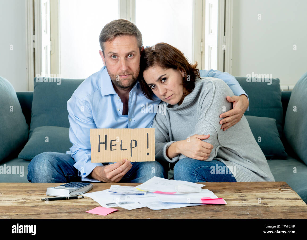 Stressed young couple accounting home finance paying bills mortgage bank statements and expenses feeling desperate having so many debts in bad financi Stock Photo