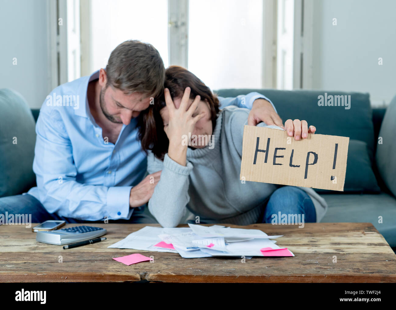 Stressed young couple needing help in accounting home finance paying bills mortgage bank statements and expenses feeling desperate having so many debt Stock Photo