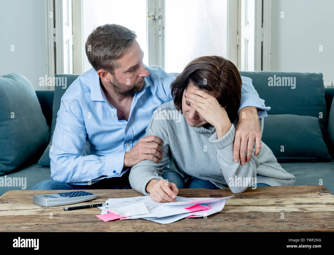 Stressed young couple accounting home finance paying bills mortgage bank statements and expenses feeling desperate having so many debts in bad financi Stock Photo