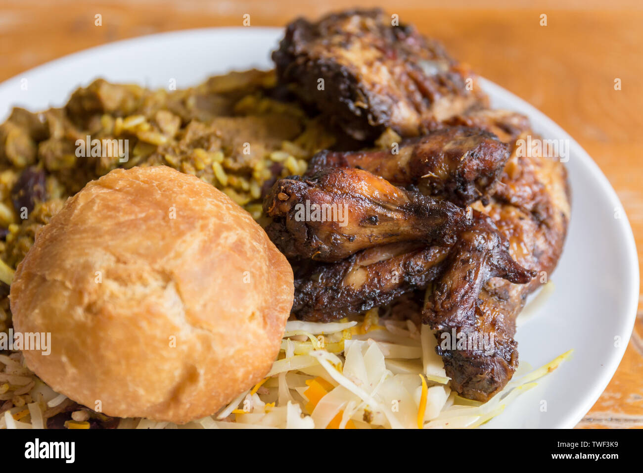 Jamaican food. Traditional Jamaican curried goat, jerk chicken and