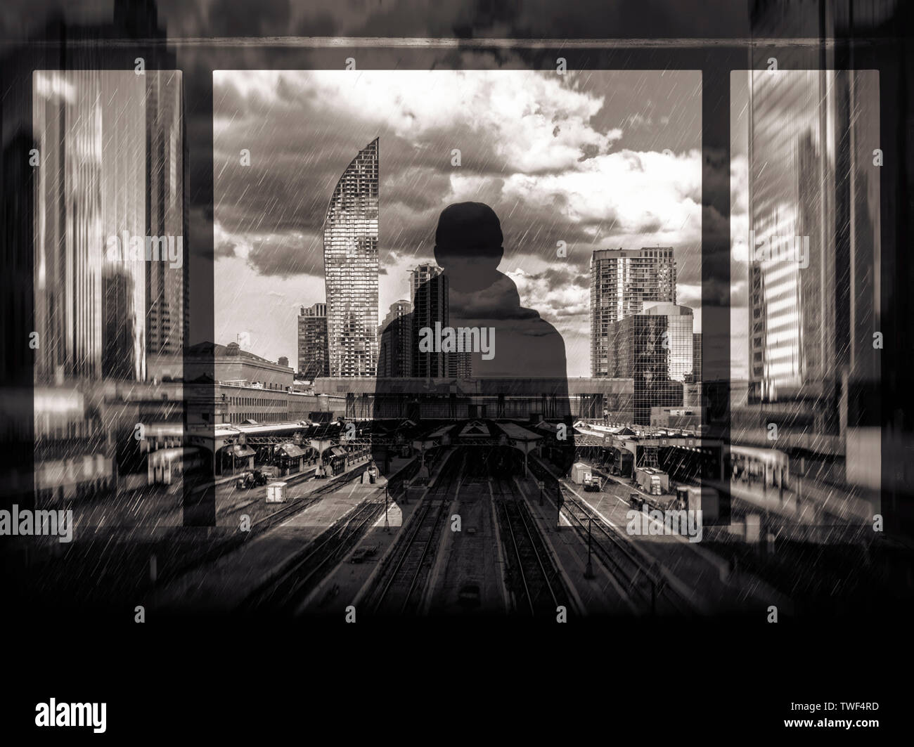 Double-exposure illustration of a person looking out across a railway terminus and city skyline in the rain Stock Photo