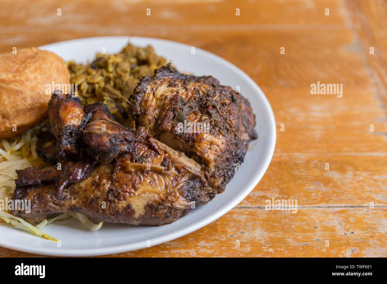 Jamaican food. Traditional Jamaican curried goat, jerk chicken and