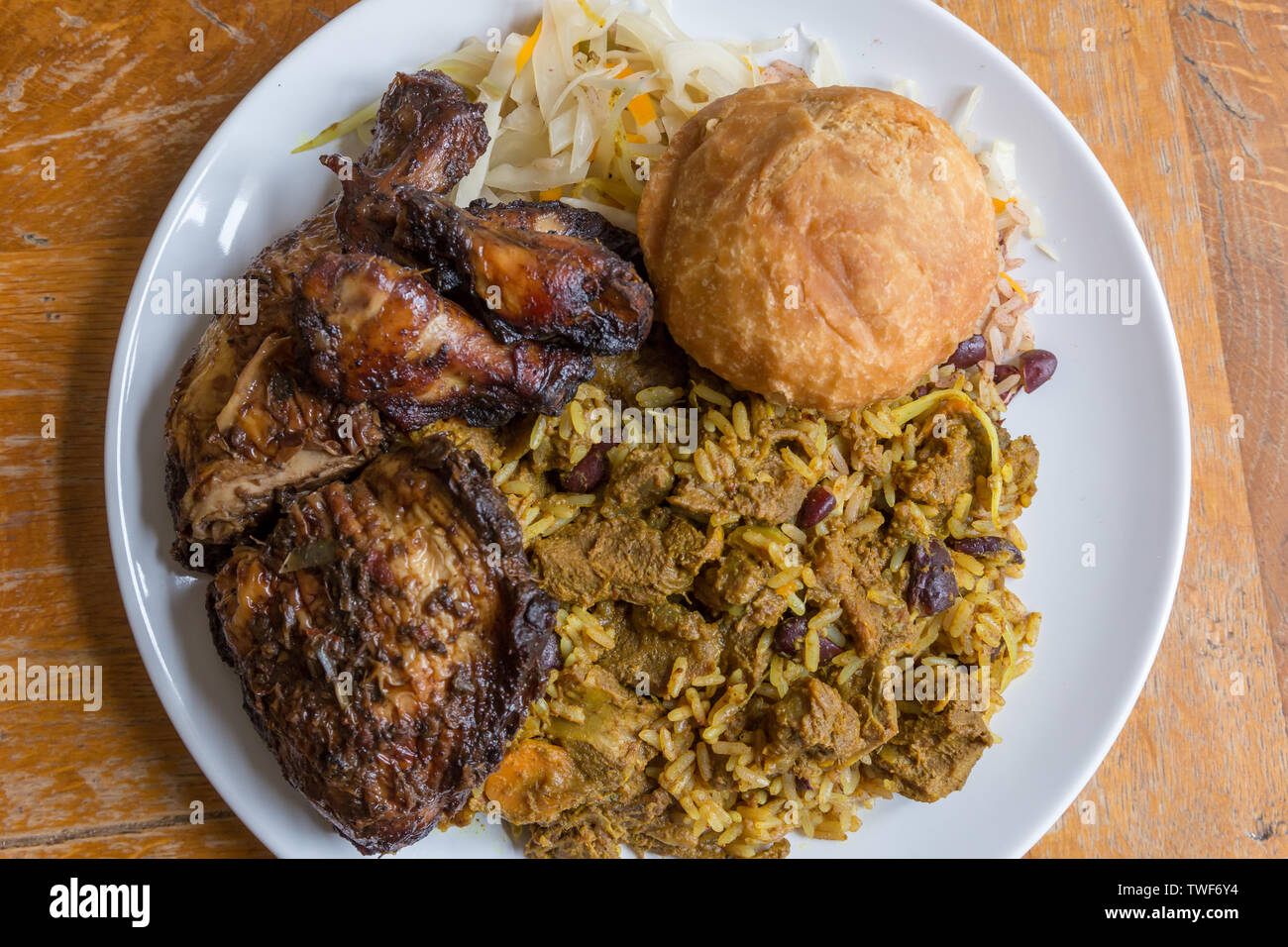 Jamaican food. Traditional Jamaican curried goat, jerk chicken and