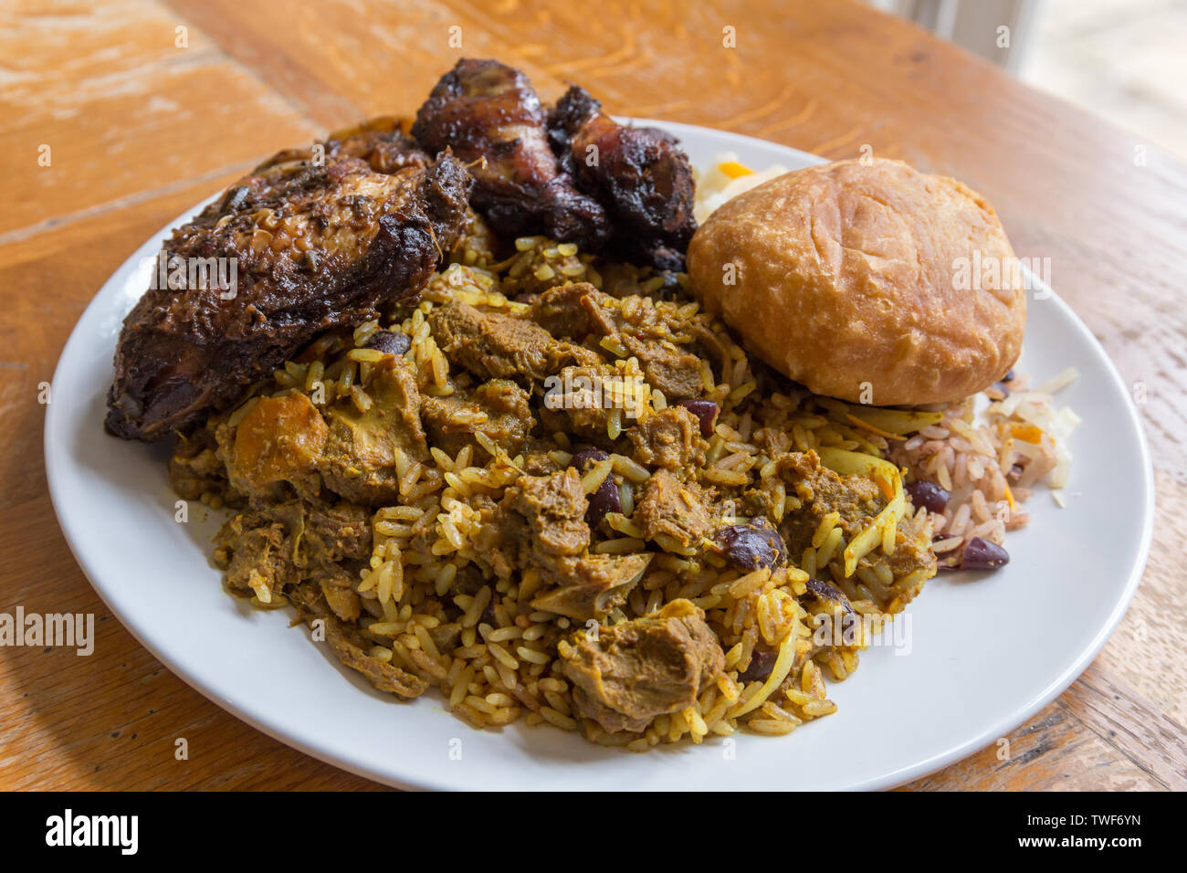 Jamaican food. Traditional Jamaican curried goat, jerk chicken and