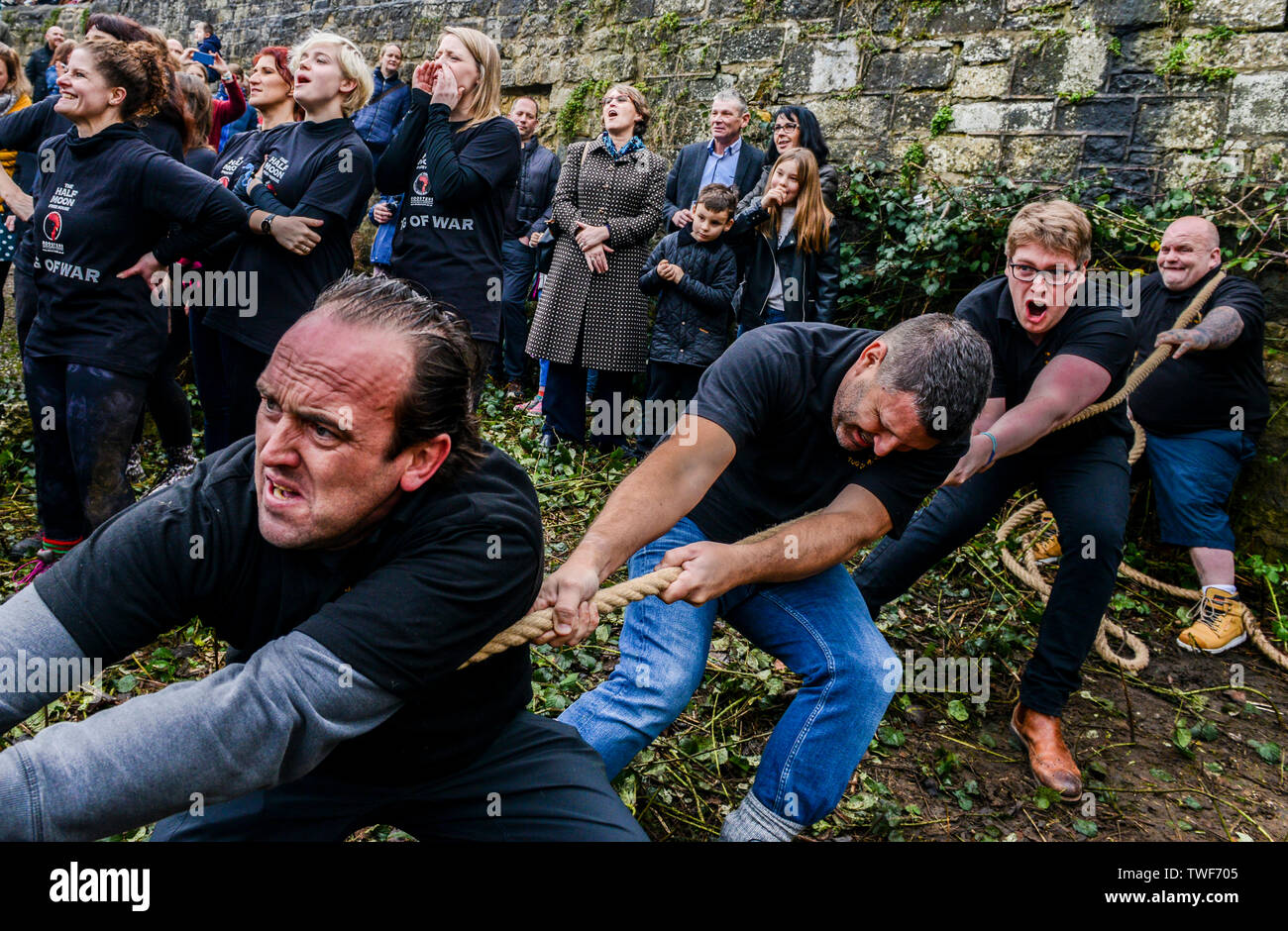 Men competing in the traditional Boxing Day Tug of War between the banks of the River Nidd with teams from the Half Moon pub and the Mother Shipton pub. Stock Photo