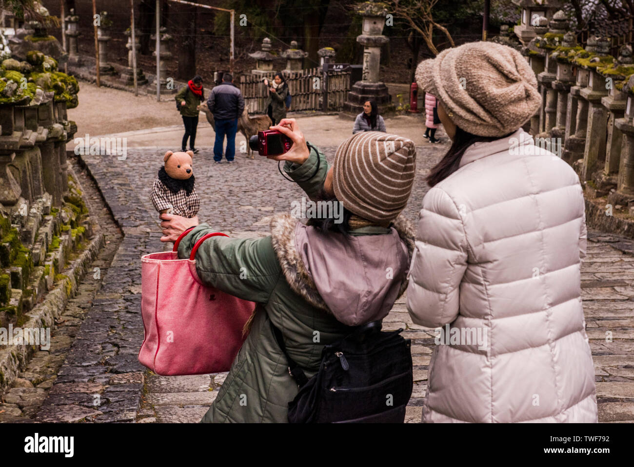 Tourists taking photographs and exploring at Nigatsu-do Temple in Nara in Japan. Stock Photo