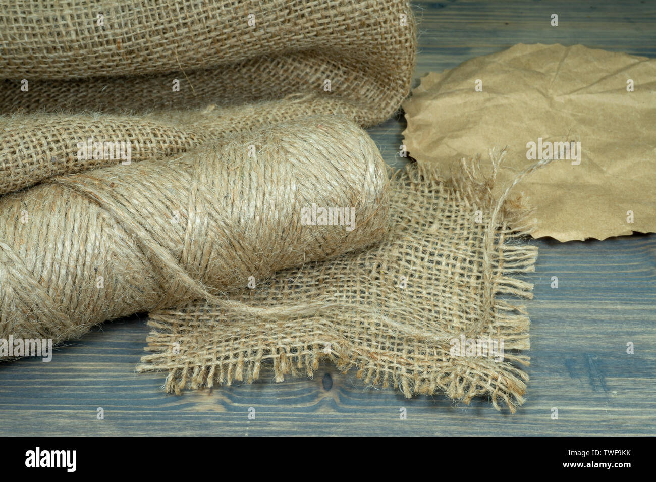 Spools of burlap threads or jute twine, sackcloth fabric in close-up on  rustic grey background Stock Photo - Alamy