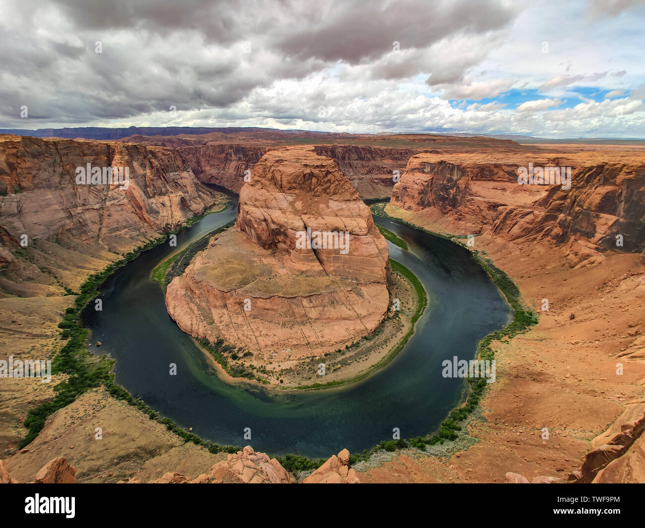 Horseshoe bend, Arizona, United States. Horseshoe-shaped incised meander of the Colorado River near the town of Page, clody sky background Stock Photo
