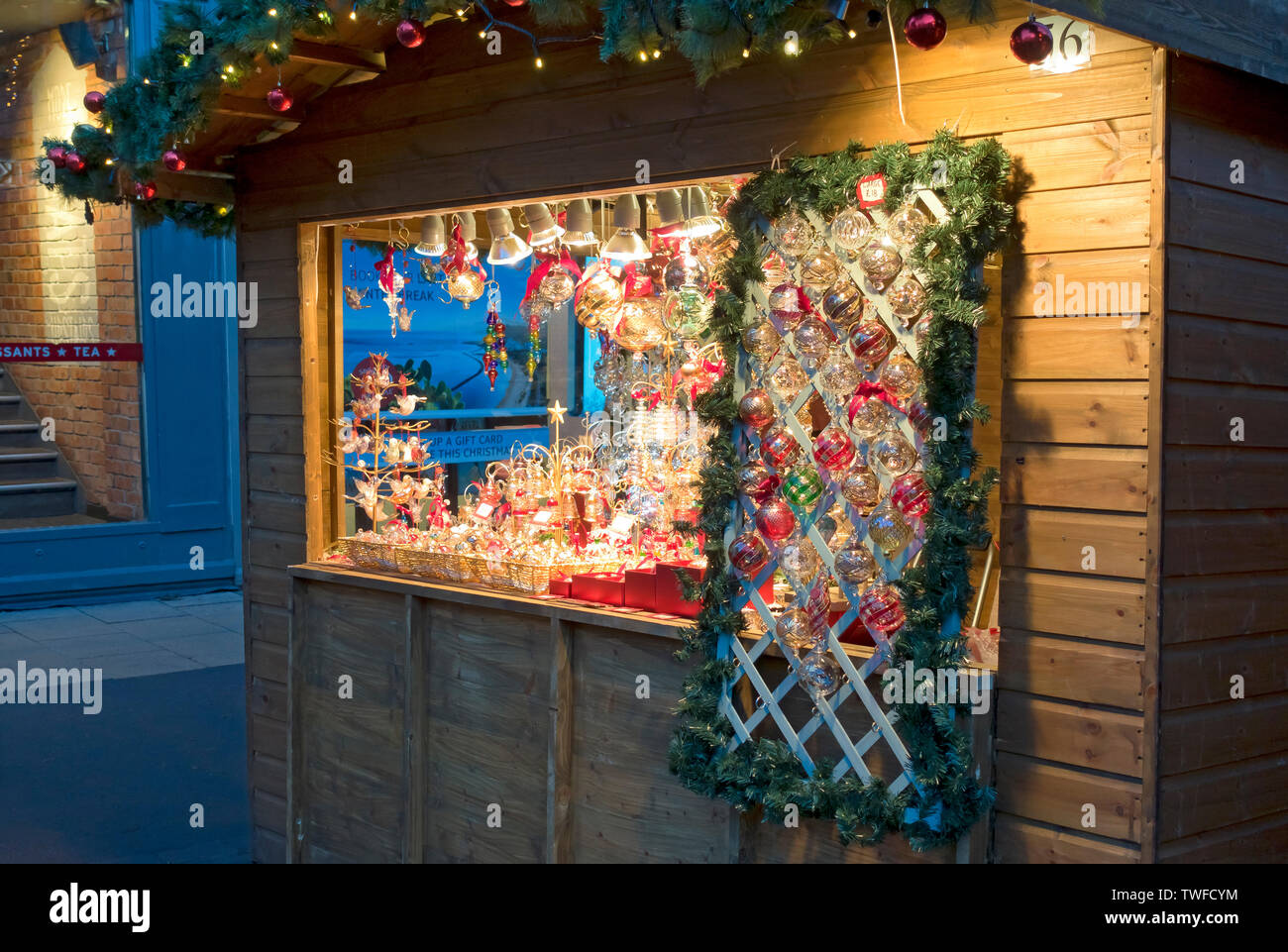 Christmas cabin selling decorations at St Nicholas Fayre. Stock Photo
