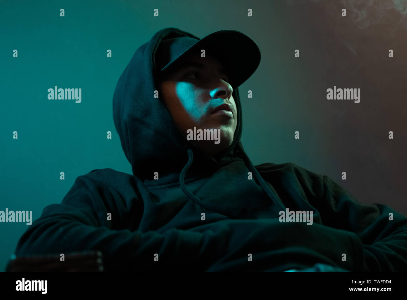 young cool rapper with black hoodie and cap looking sideways Stock Photo -  Alamy