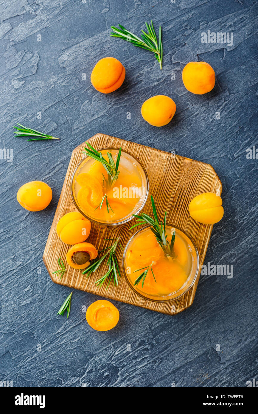 Summer drinks, rosemary aprcot cocktails with ice in glasses. Refreshing summer homemade