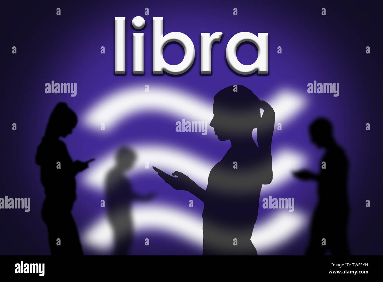 Silhouettes of people using Internet connected mobile devices to transfer money using Facebook's Libra cryptocurrency blockchain technology service. Stock Photo