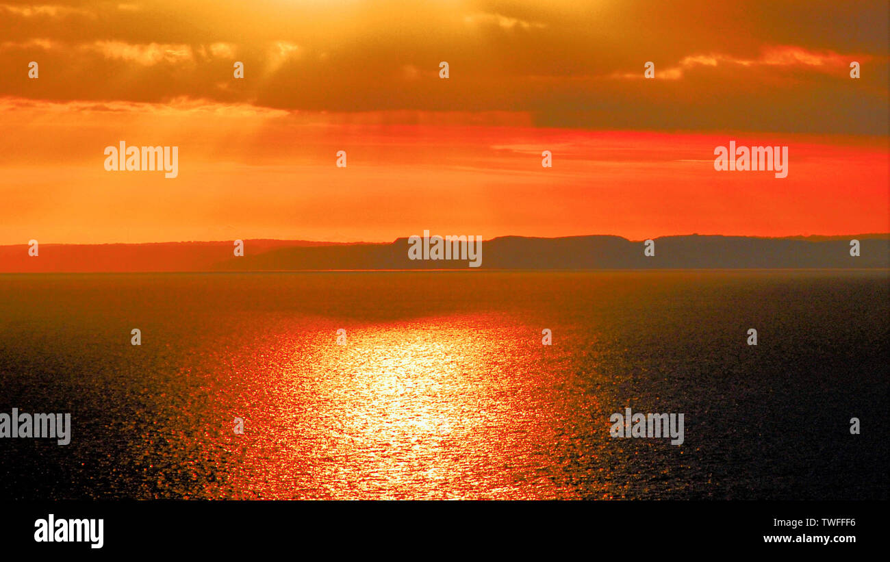 Chesil Beach. 19th June 2019. Clouds hang over Chesil Beach, as the sun