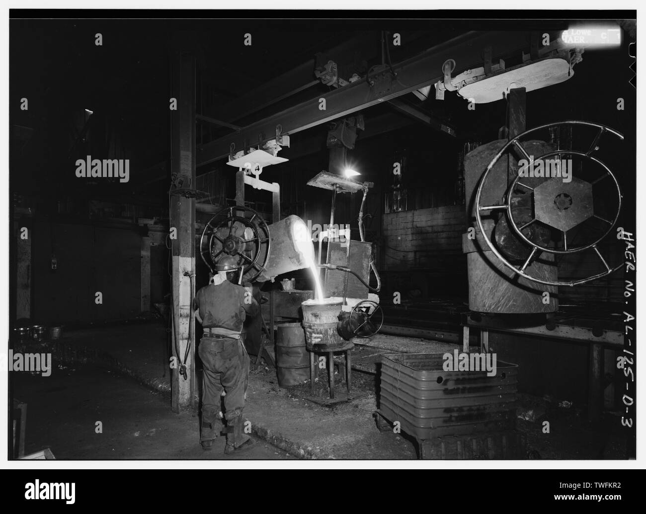 POURING IRON FROM BULL LADLE INTO MOBILE LADLES USED TO FILL MOLDS ON ...