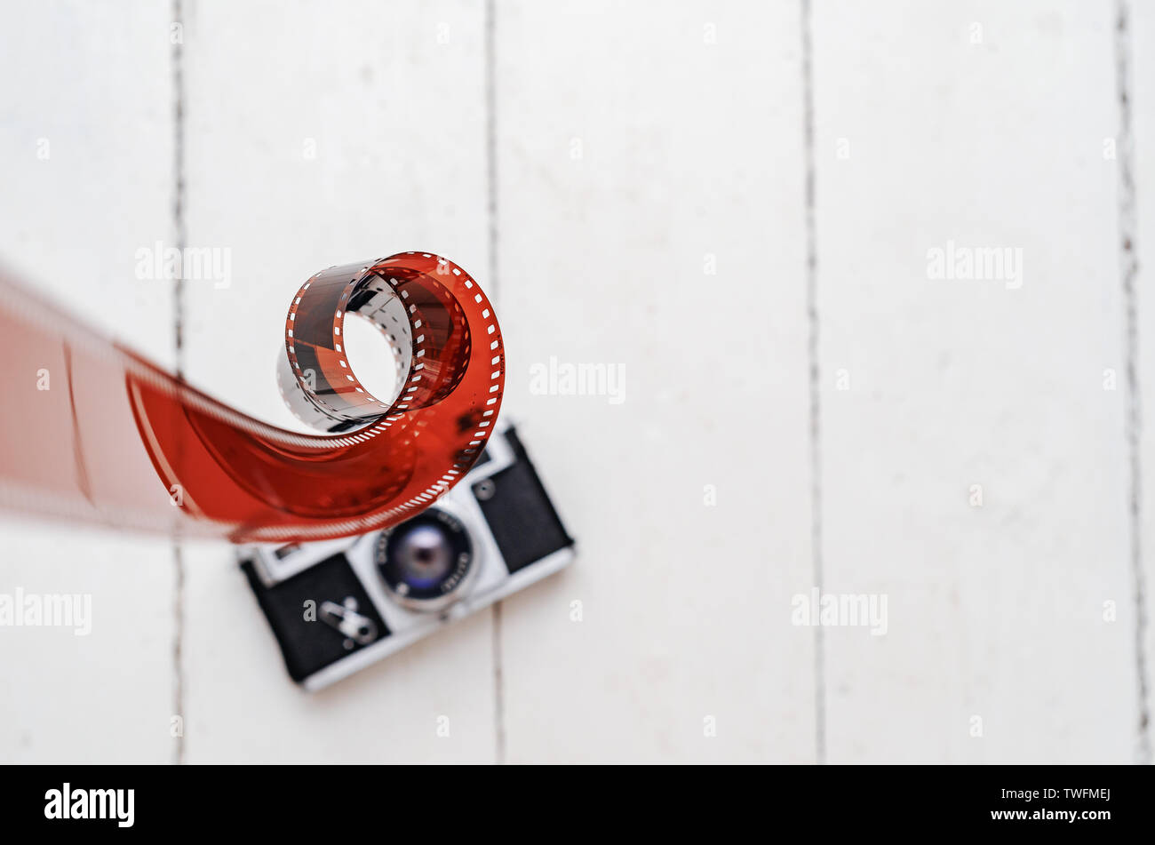Vintage old camera with 35mm red film. Old equipment. Stock Photo