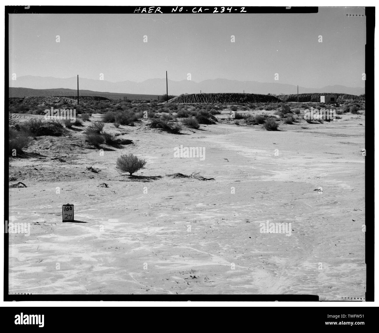 PROTECTIVE BERM SURROUNDING LAUNCH AREA AT EAST END OF TRACK. WATER PUMP STATION 0540 AT FAR RIGHT. Looking from northeast of Station 0. - Edwards Air Force Base, South Base Sled Track, Edwards Air Force Base, North of Avenue B, between 100th and 140th Streets East, Lancaster, Los Angeles County, CA Stock Photo